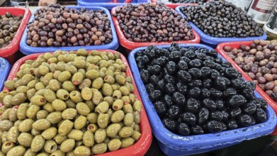 Colourful containers with different types of olives (olivae) at a market, Skopje, North Macedonia