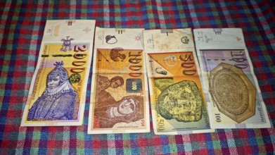 Different denarius banknotes from North Macedonia on a colorful tablecloth, Skopje, North Macedonia