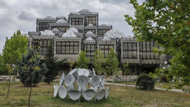 Architecturally distinctive building with domes and surrounding nature, National Library, Pristina,