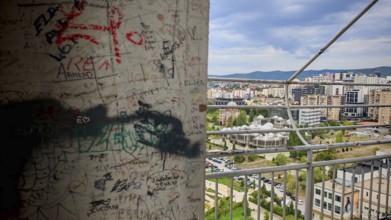 Wall with graffiti and cityscape in the background, Pristina, Kosovo