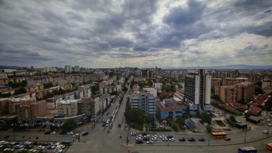 City panorama with dramatic cloudy sky and buildings, Pristina, Kosovo