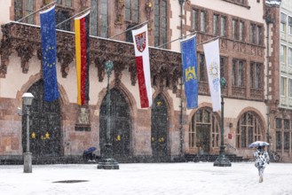 A passer-by walks across Frankfurt's Römerberg with an umbrella. Heavy snowfalls have caused