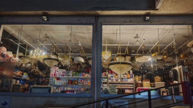 An illuminated shop with various lights and lamps in a shop window, Kosovo