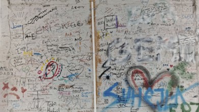 Wall full of colorful graffiti and doodles separating two different sections, Pristina, Kosovo