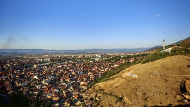 Wide view of a city and surrounding hills under blue sky, Prizren, Kosovo