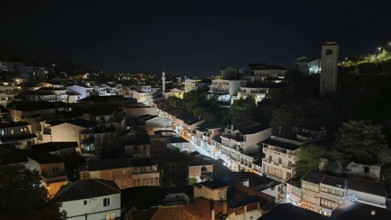 Night view of illuminated cityscape with houses and roads in darkness, Montenegro