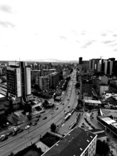 Black and white city view with modern buildings and sustained road traffic, Pristina, Kosovo