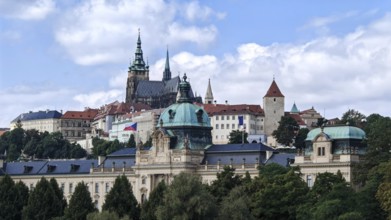 Historic buildings and towers under blue sky in an urban landscape, view of Hradcany, Prague Czech