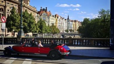 Driving a classic car, sightseeing, sightseeing along a street lined with historic buildings in