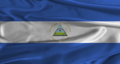 Flag of Nicaragua with fabric textured background. Close up of National flag of Nicaragua with