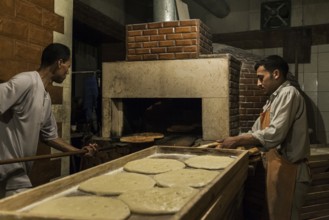 Tripoli, Libya, North Africa. Making traditional pita bread in an old bakery in the historic part