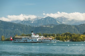 Lake Lucerne, Switzerland, Europe. A traditional boat on Lake Lucerne with the Swiss Alps in the