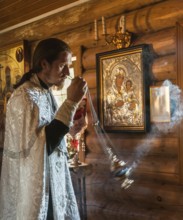 Yuzhno Sakhalin, Sakhalin, Russia. A Russian Orthodox priest during a religious ceremony in a