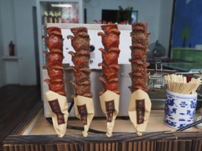 Various spiced meat skewers are presented at a street food market, Zhujiajiao Ancient Town,