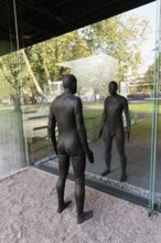 Male figure looking at her real reflection, Reflections II sculpture by sculptor Antony Gormley,