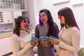 Three smiling young women friends wearing stylish sunglasses and casual clothes sharing a happy