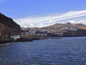 Coastal town with buildings along the sea line under a blue sky, Sardina del Norte, Gran Canaria,