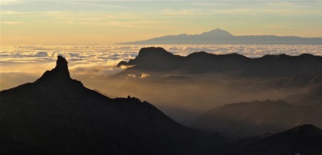 Atmospheric mountain scenery at sunset over a sea of clouds, Roque Nublo, Gran Canaria, Canary