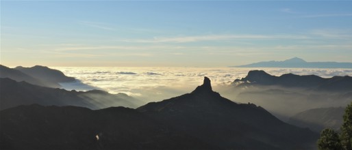 Unique mountain silhouette at sunset over a sea of clouds, Roque Nublo, Gran Canaria, Canary