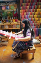 Maya woman, 42 years old, weaving with a back strap, traditional craft in a woman's cooperative,
