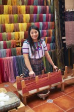 Maya woman, 42 years old, working on a weaving frame, traditional crafts in a woman's cooperative,
