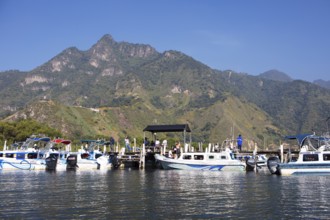 Colourful boats in the port of San Juan la Laguna, the mountains behind, Atitlán, Sololá