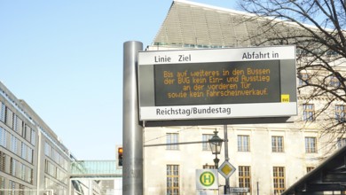 Bus stop with digital information sign in the city, sign during corona, Berlin