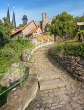 Narrow steep alleyway with cobblestones in the small village of Rimbach below the ruins of Hanstein