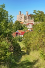 View of the ruins of Hanstein Castle and the small village of Rimbach with half-timbered houses,