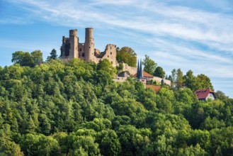 View of the ruins of Hanstein Castle and the small village of Rimbach, village church with