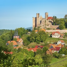 View of the ruins of Hanstein Castle and the small village of Rimbach, half-timbered village church