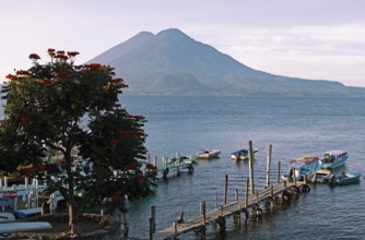 Boats on the dock, Lake Atitlán or Lake Atitlán in the morning, the volcanoes Atitlán and Toliman