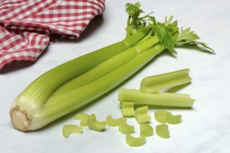 Celery stalks, celery pieces and knife