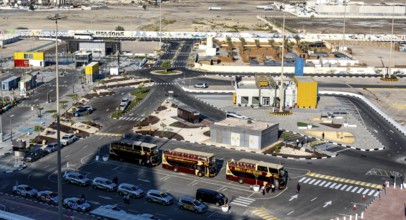 Taxi and hop on hop off buses are waiting for tourists in the cruise terminal parking lot, Abu
