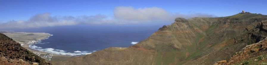 Extensive panorama with mountains and sea in the background under blue sky, Mirador de Ermita de