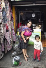 Mayan woman with toddler in traditional clothes at the market in Chichicastenango, Highlands, El