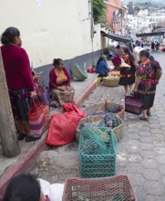 Mayan woman wearing traditional clothing sell chickens on the street in Chichicastenango,