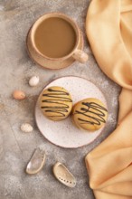 Caramel Cream Cakes on brown concrete background, cup of coffee, top view, flat lay, close up