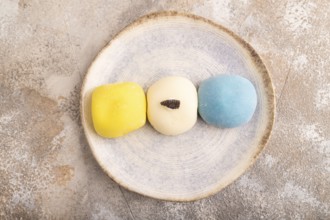 Japanese Mochi Cakes on brown concrete background, top view, flat lay, close up