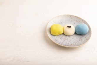Japanese Mochi Cakes on white wooden background, side view, copy space