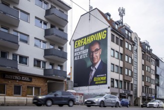 Mega poster on a house pediment. Cem Özdemir, leading candidate of the Green Party. 2026 state