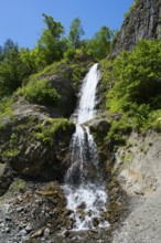Small waterfall falling over green rocks, waterfall near Dizi, road 7, Mingrelia and Upper Svaneti