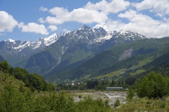 Majestic snow-capped mountains under a cloudy sky, view from Majvdieri of Mount Tetnuldi, Mestia