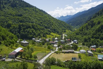 Village nestled in a green valley with mountains in the background, Bogreshi, road 7, Mingrelia and