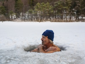 Man with cap, 55, ice bathing in an ice hole, Thumsee, Bad Reichenhall, Berchtesgadener Land, Upper