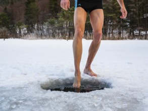Naked men's legs at an ice hole, toes in water, Thumsee, Bad Reichenhall, Berchtesgadener Land,