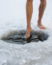 Naked men's legs at an ice hole, toes in water, Thumsee, Bad Reichenhall, Berchtesgadener Land,
