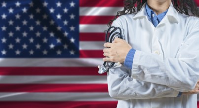 Healthcare professional with United States flag background. Professional doctor holding stethoscope
