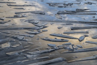 Pieces of ice and clouds reflecting on the water surface, lake, winter, Finland