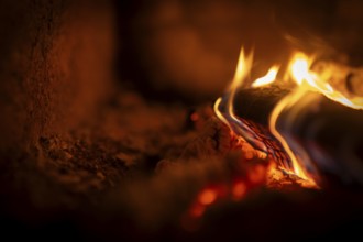 Burning wood, log, embers, fire in a fireplace